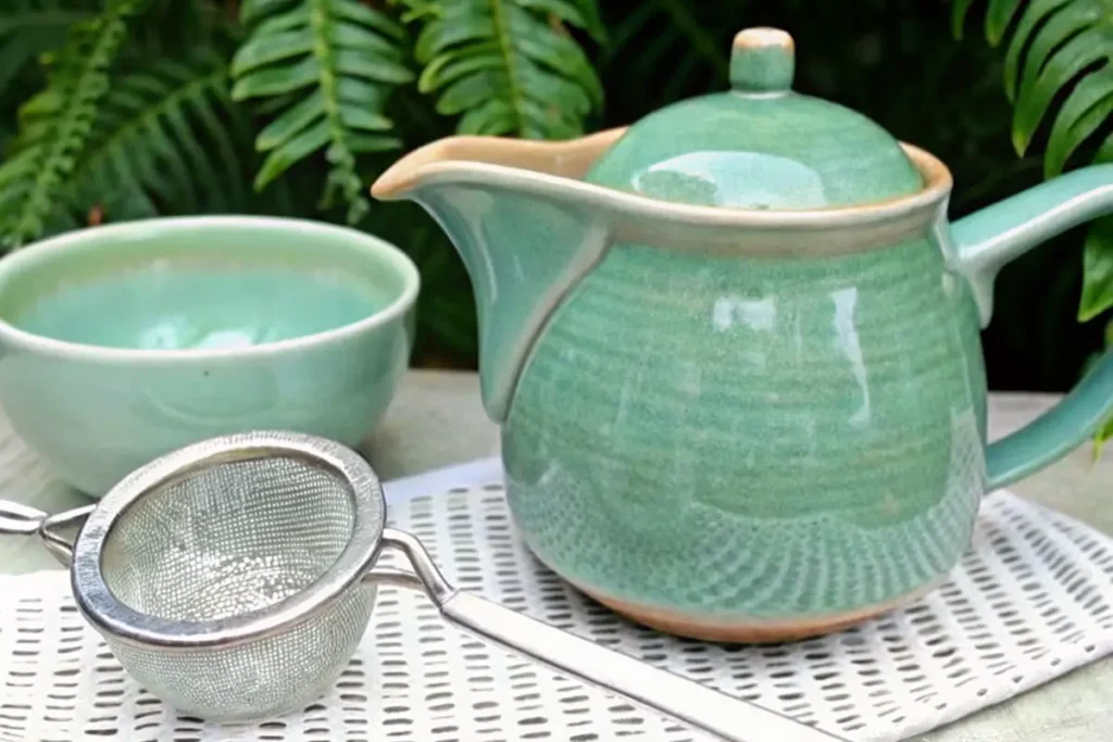 Coconut Milk Green Tea: Creamy, Healthy & Dairy-Free Recipes 7 Ceramic teapot and tea strainer setup for making coconut milk green tea